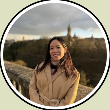 Joy outdoors in a camel-colored coat